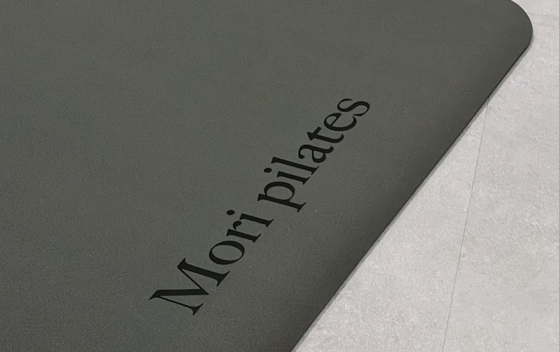 Mori Pilates logo engraved on a studio mat